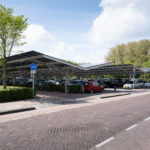Solar energy panels installed on the canopy of a car parking area in the center of the Dutch city Dronten. Sustainable energy and shade at the same time